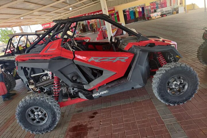 Experience the excitement of driving a Polaris Dune Buggy across endless sand dunes with a chance to enjoy camel rides and dune bashing in breathtaking desert landscapes. Adventure awaits!